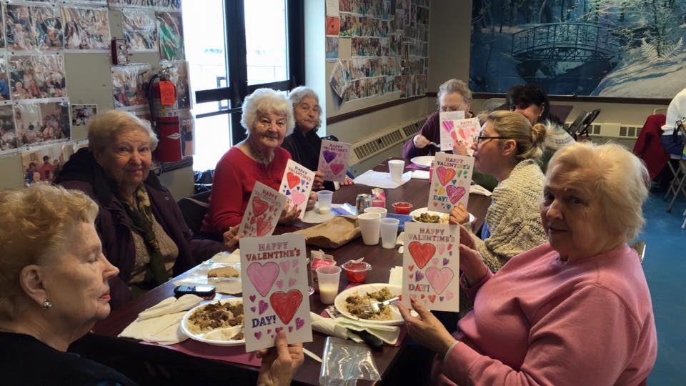 Assemblywoman Kimberly Jean-Pierre handing out Valentines cards to senior citizens.