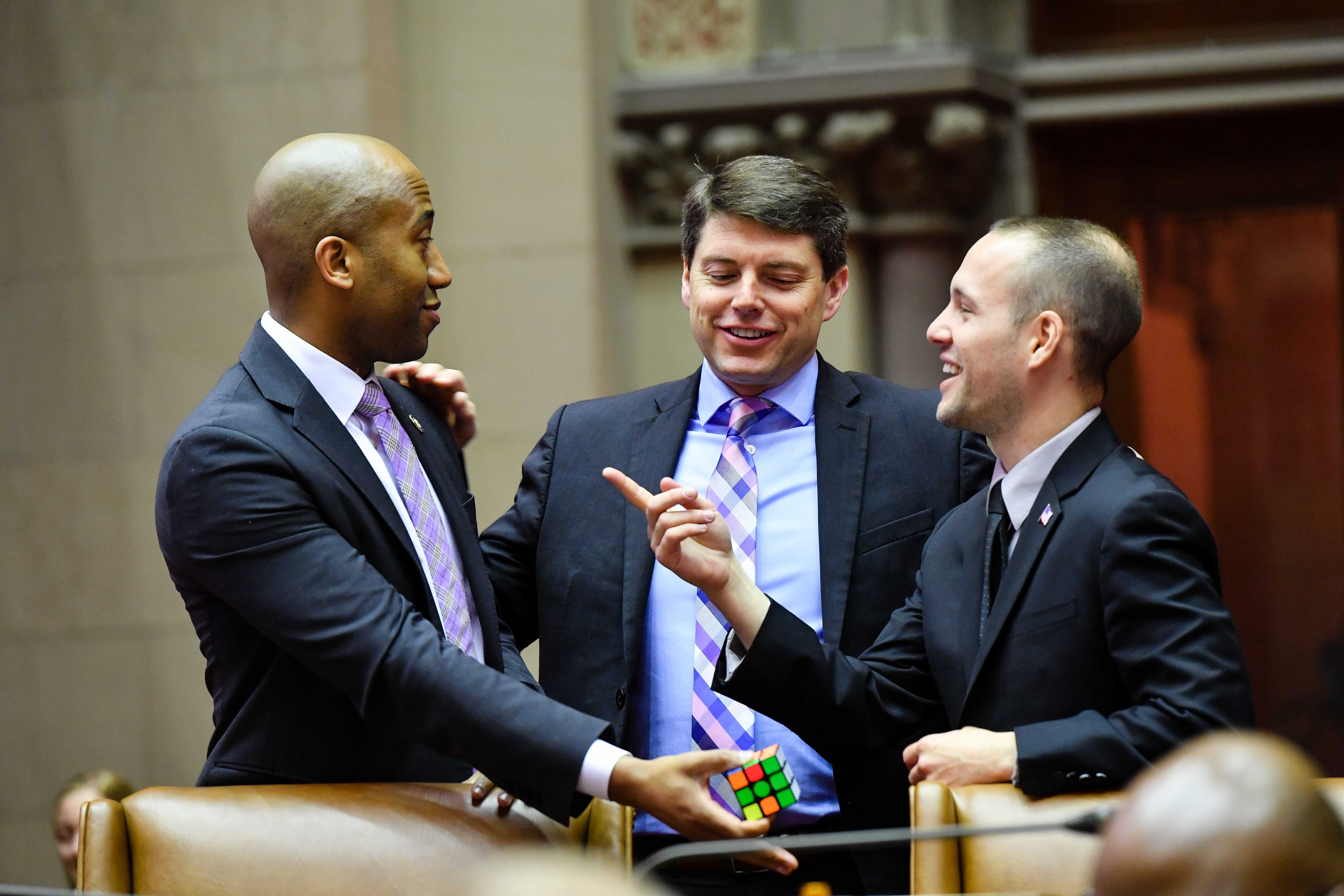 Assembly member Vanel bonding over Rubik’s cubes with Assembly colleagues.