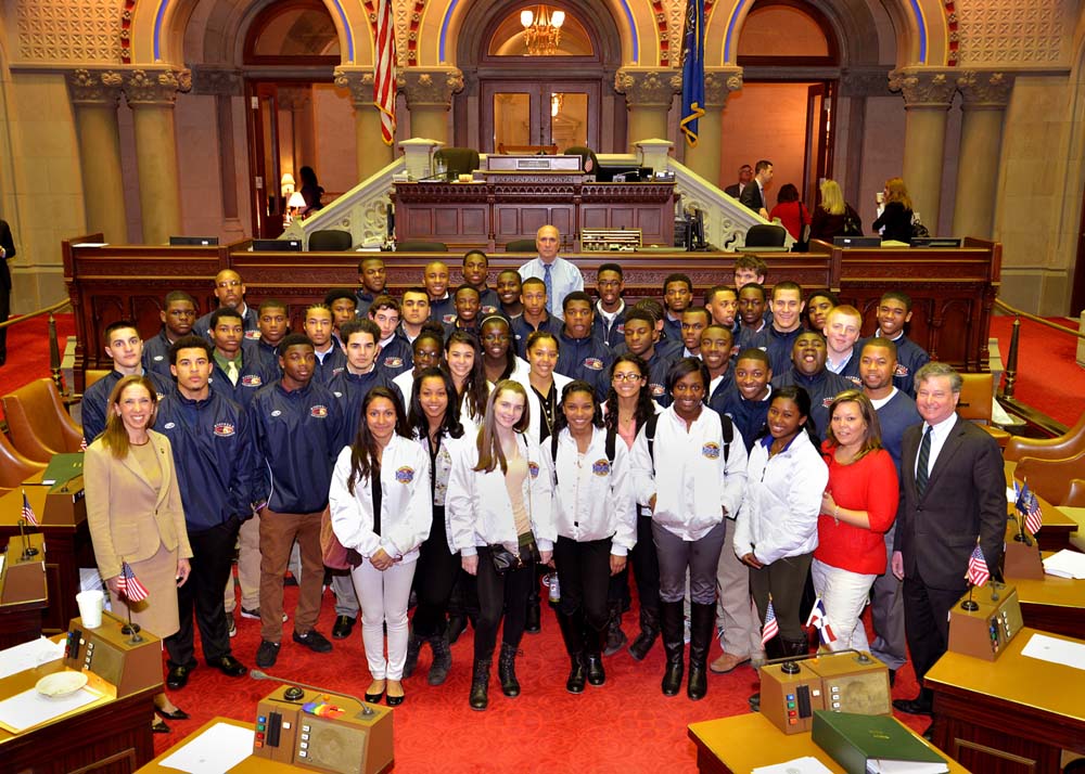 Assemblyman Otis, joined by Assemblywoman Paulin, welcomes the championship football and cheerleading teams of New Rochelle High School and celebrates their outstanding athletic achievements.