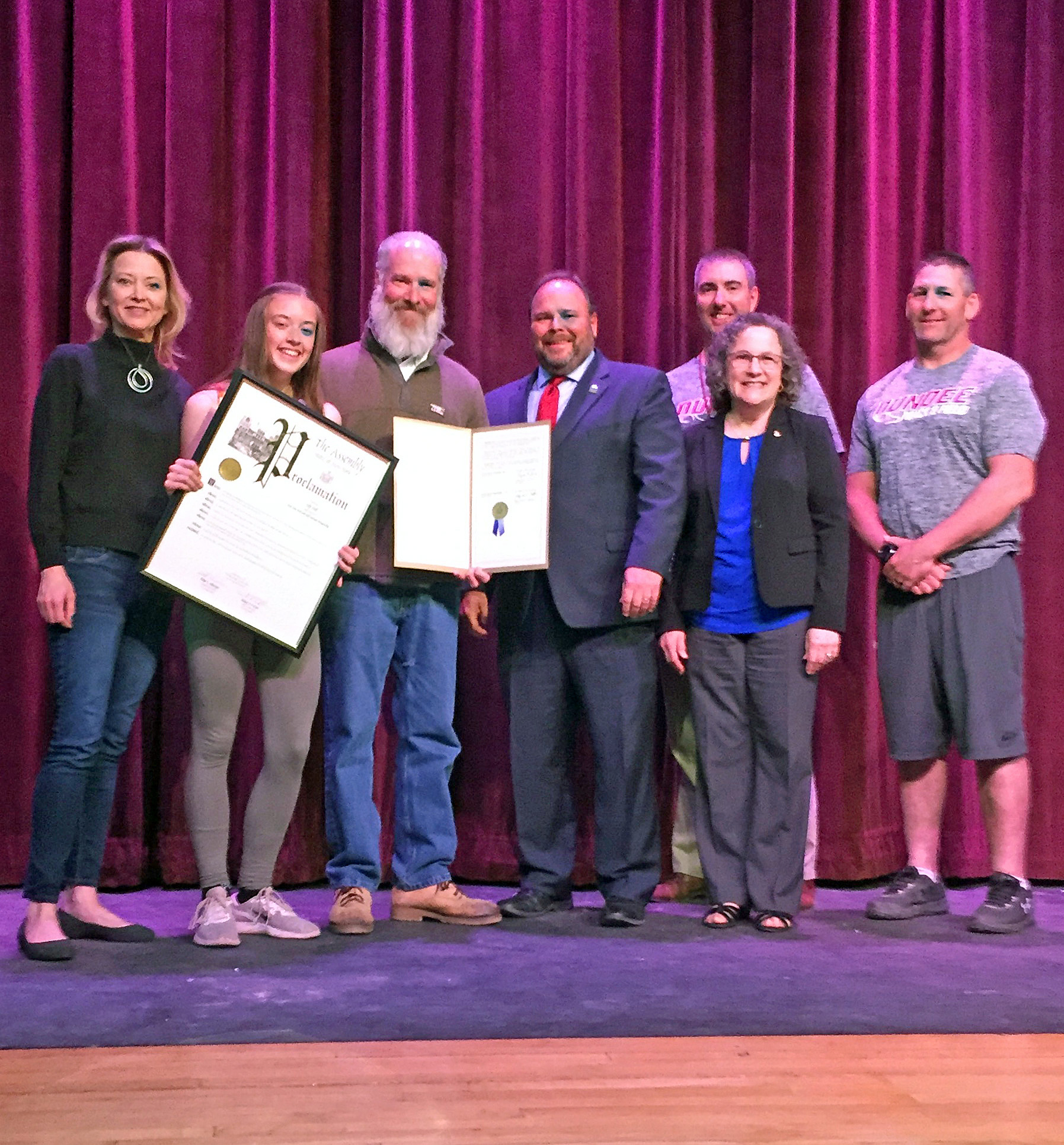 From left to right: Macy Hall, Lilys mother, Lily, Lilys father William Hall, Assemblyman Palmesano, Varsity Boys Track Coach Scott Shepardson, Sharon Sitrin-Moore, and Varsity Girls