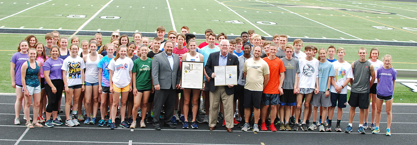 On the track at the Corning-Painted Post High School on Tuesday, May 28, from left to right in the center of the front row, Assemblyman Palmesano, Lindsey Butler, Senator OMara, and Head Coach J