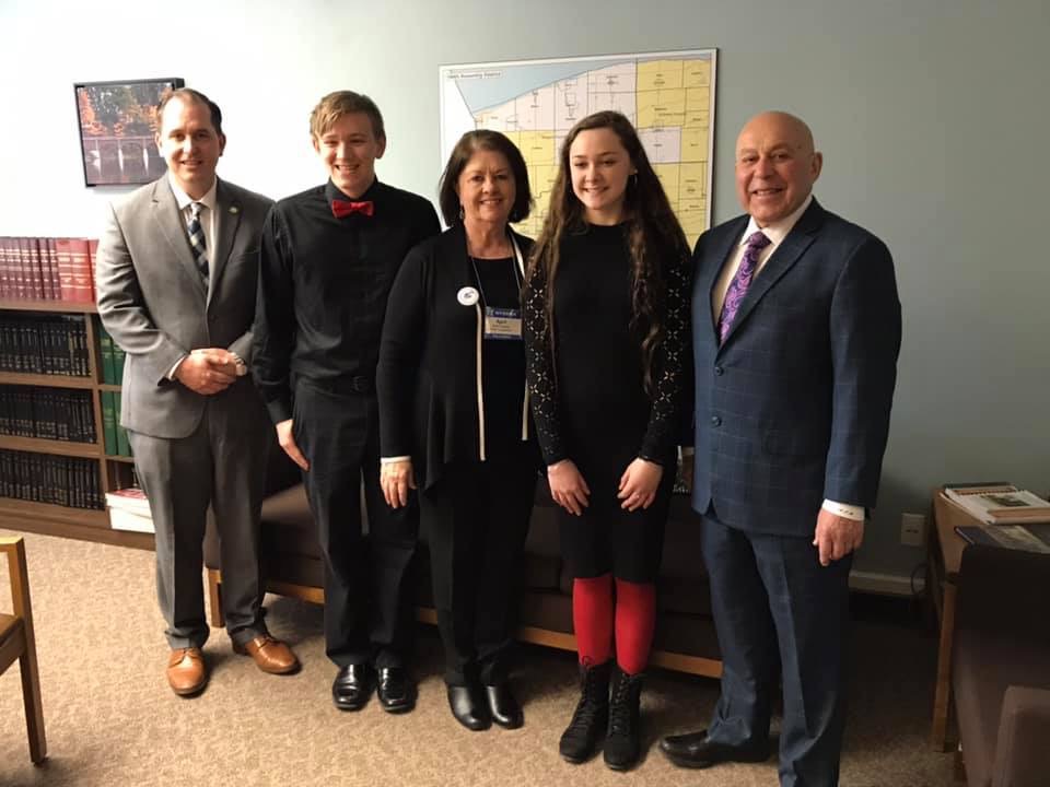 Assemblyman Mike Norris (far left) welcomes student musicians Austin Dick (second from left) and Samantha Campbell (second from right) to Albany on March 4, 2019. The students were in town to perform