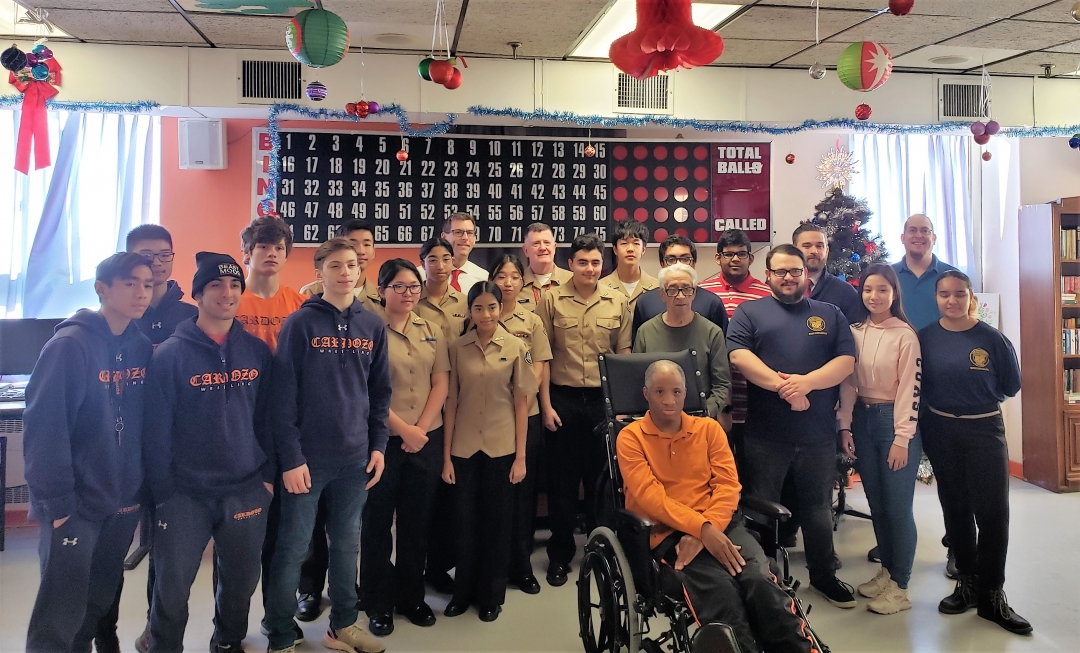 Assemblyman Braunstein, his staff, and students and faculty from Benjamin N. Cardozo High School are pictured with veterans at the St. Albans VA Community Living Center on December 20, 2019.